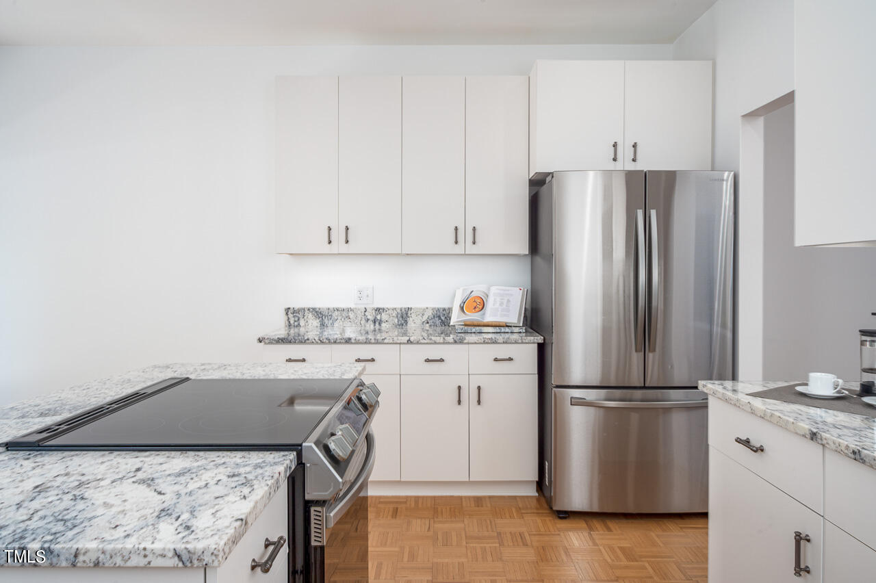 479 Beechmast Pittsboro, NC 27312 - Photo 8 of 22 a kitchen with a refrigerator and a stove top oven