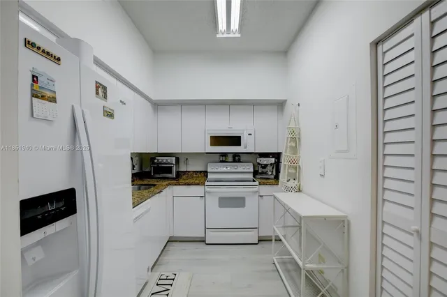 a kitchen with a refrigerator sink and stove