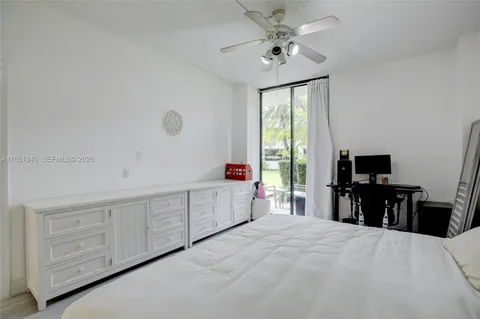 a large white bedroom with a bed and a chandelier