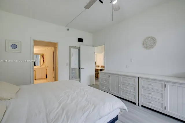 a bedroom with bed and cabinets