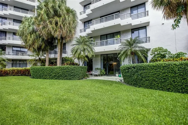 a view of a house with a yard and plants