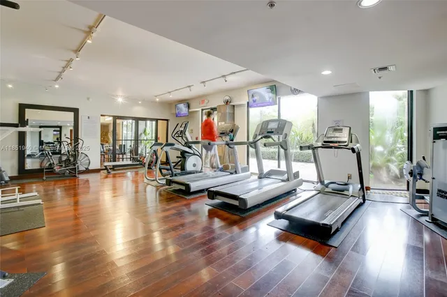 a view of a room with gym equipment and a large window