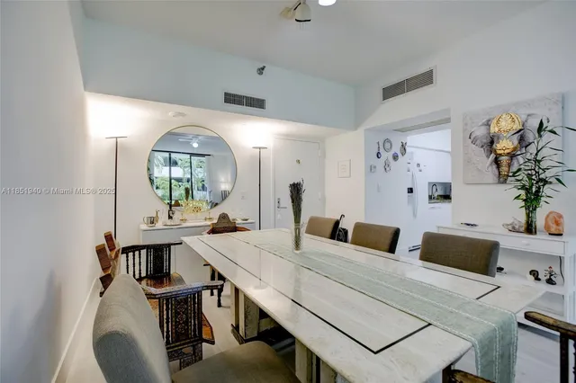 a view of a dining room with furniture and a chandelier