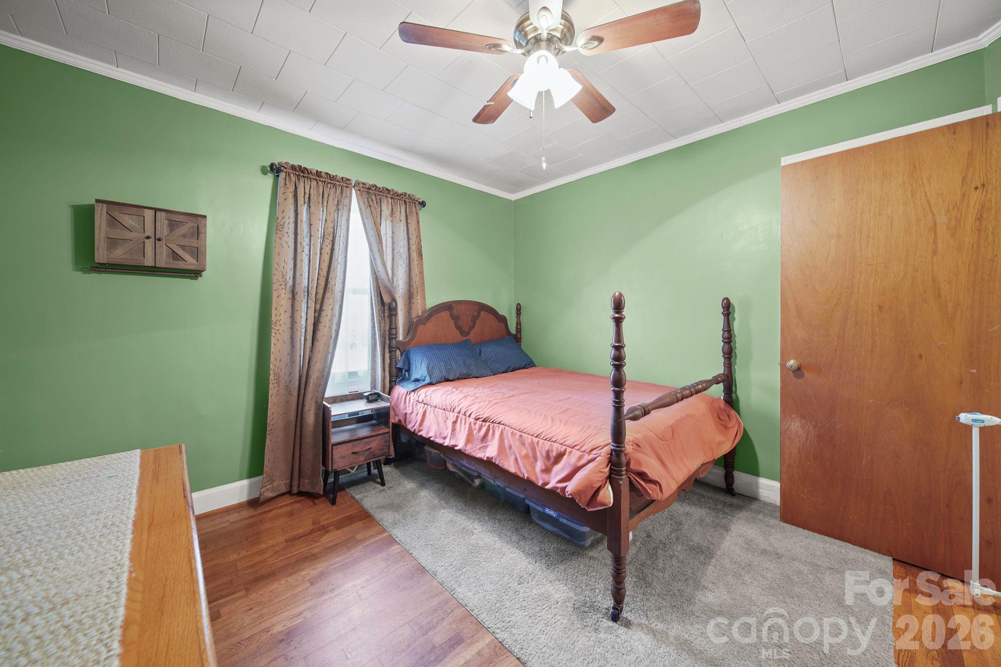 1787 St Johns Church Road Concord, NC 28025 - Photo 18 of 34 a bedroom with a bed and a chandelier