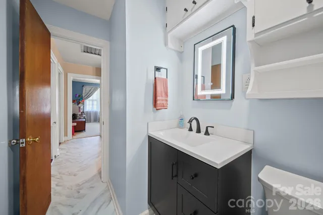 a spacious bedroom with a bed and a chandelier