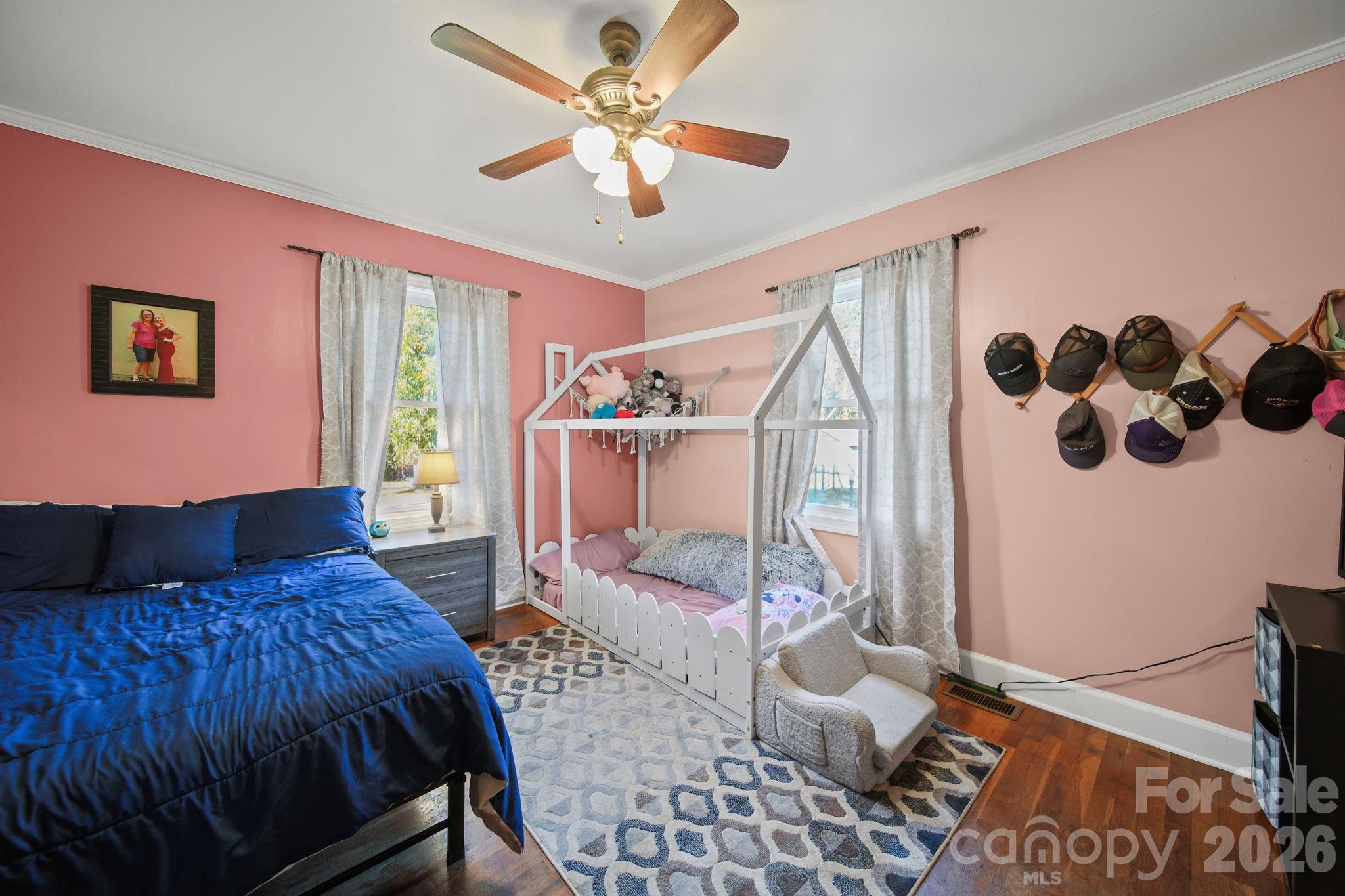 1787 St Johns Church Road Concord, NC 28025 - Photo 21 of 34 a spacious bedroom with a bed and a chandelier