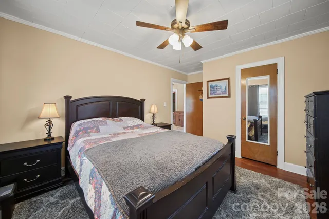 a bedroom with a bed and a television