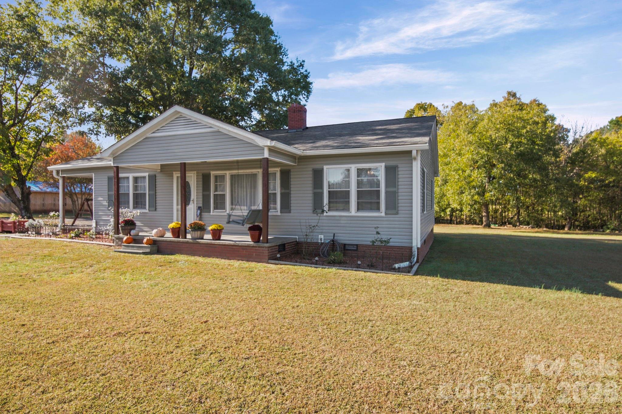 1787 St Johns Church Road Concord, NC 28025 - Photo 27 of 34 a front view of a house with swimming pool and porch