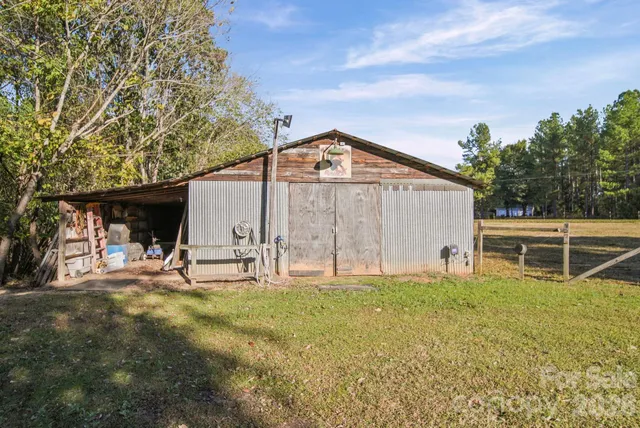 a view of a patio with table and chairs under an umbrella