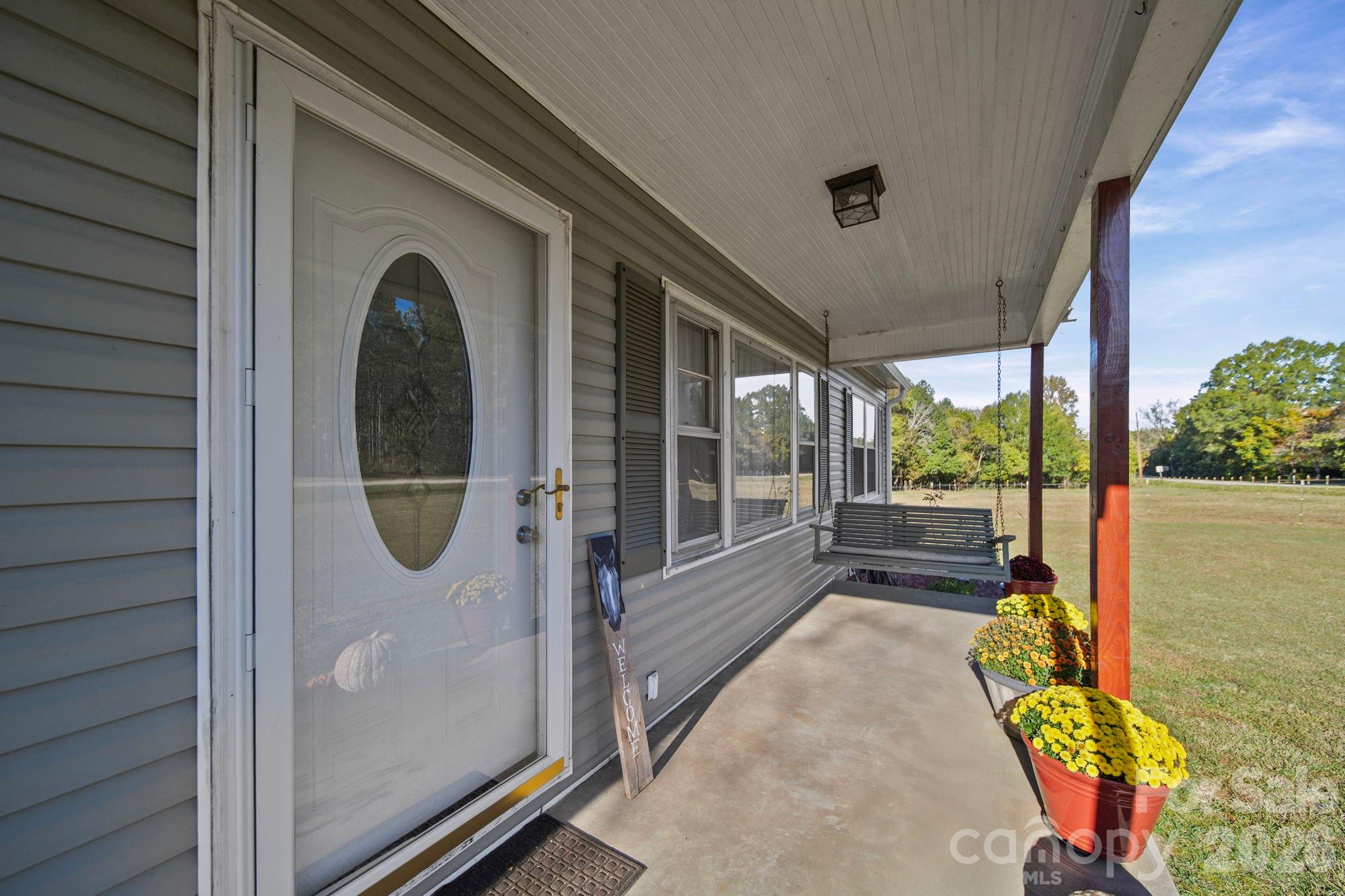 1787 St Johns Church Road Concord, NC 28025 - Photo 3 of 34 a view of a porch with furniture