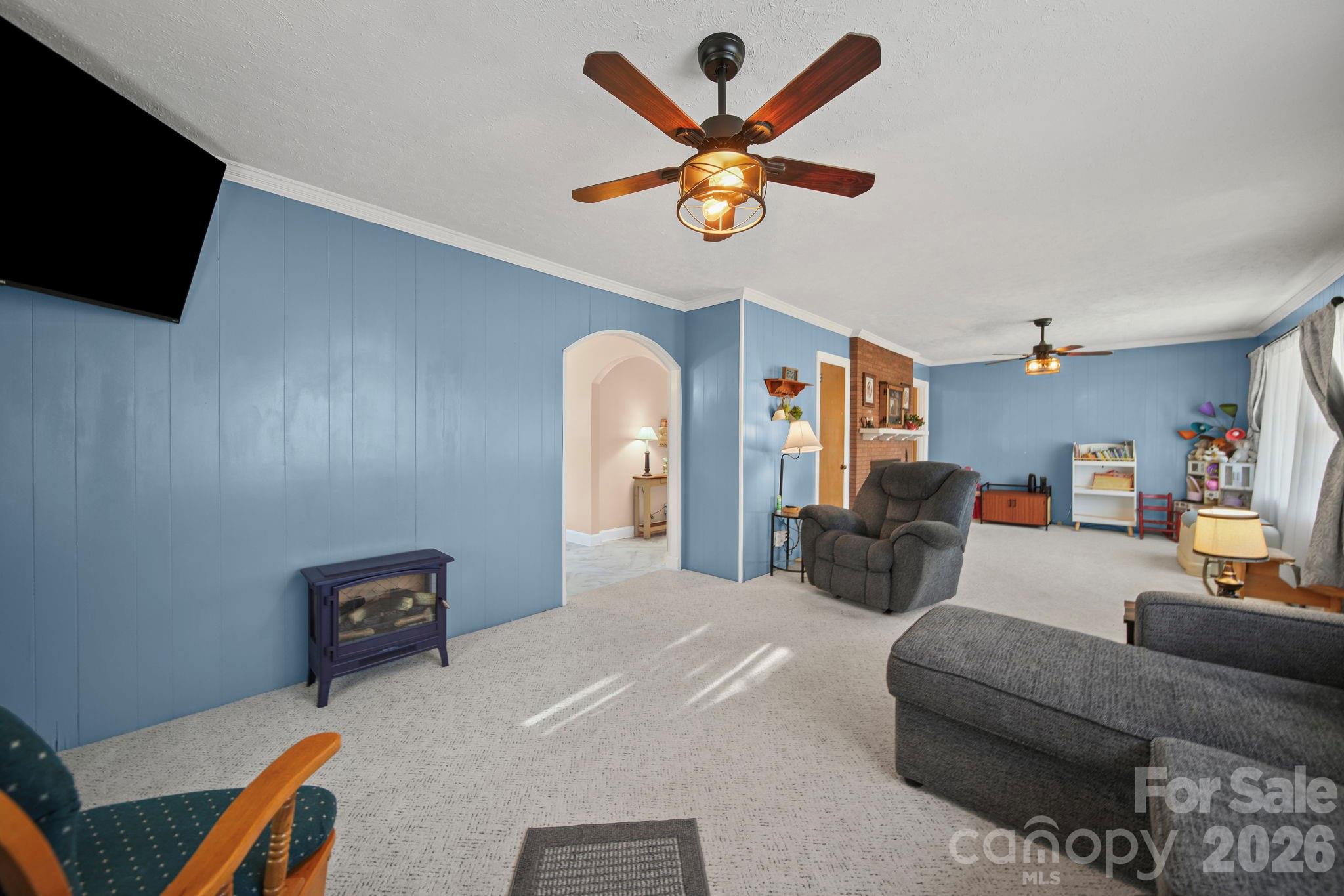 1787 St Johns Church Road Concord, NC 28025 - Photo 5 of 34 a living room with furniture a ceiling fan and a flat screen tv