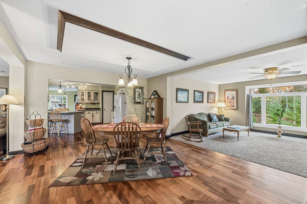 5251 Grabert Road Duluth, MN 55803 - Photo 12 of 50 Dining space featuring dark wood-style flooring, a chandelier, and a ceiling fan