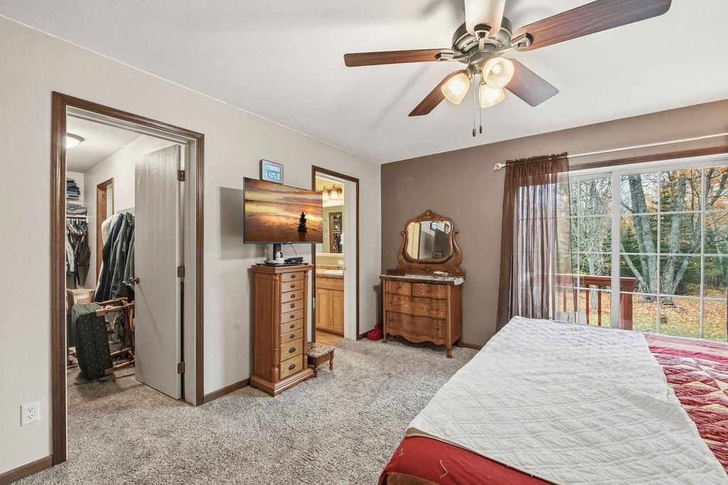 5251 Grabert Road Duluth, MN 55803 - Photo 20 of 50 Bedroom featuring a spacious closet, light carpet, access to exterior, ceiling fan, and ensuite bath