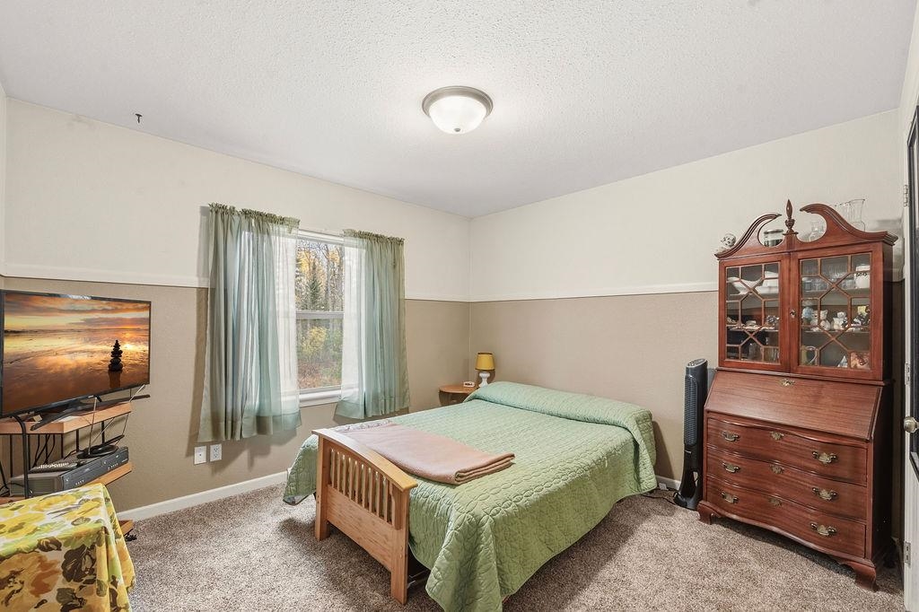 5251 Grabert Road Duluth, MN 55803 - Photo 30 of 50 Bedroom with a textured ceiling and light carpet