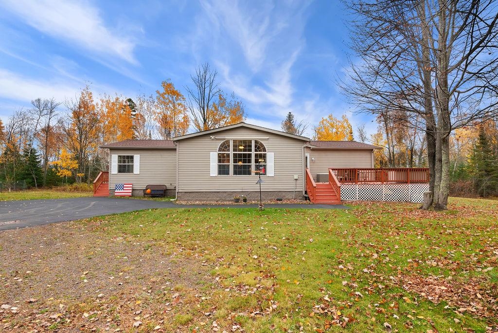 5251 Grabert Road Duluth, MN 55803 - Photo 34 of 50 View of front facade featuring a front yard, a wooden deck, crawl space, and stairway
