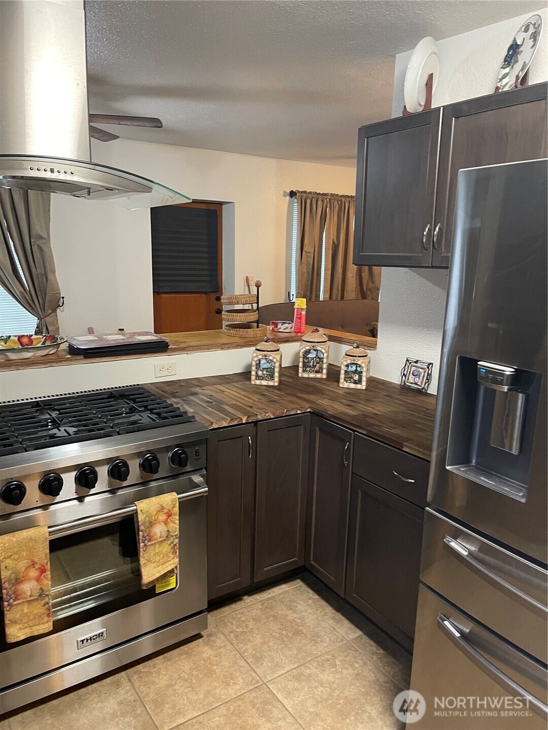 212 West 4th Street Tonasket, WA 98855 - Photo 7 of 24 a kitchen with a stove and a refrigerator