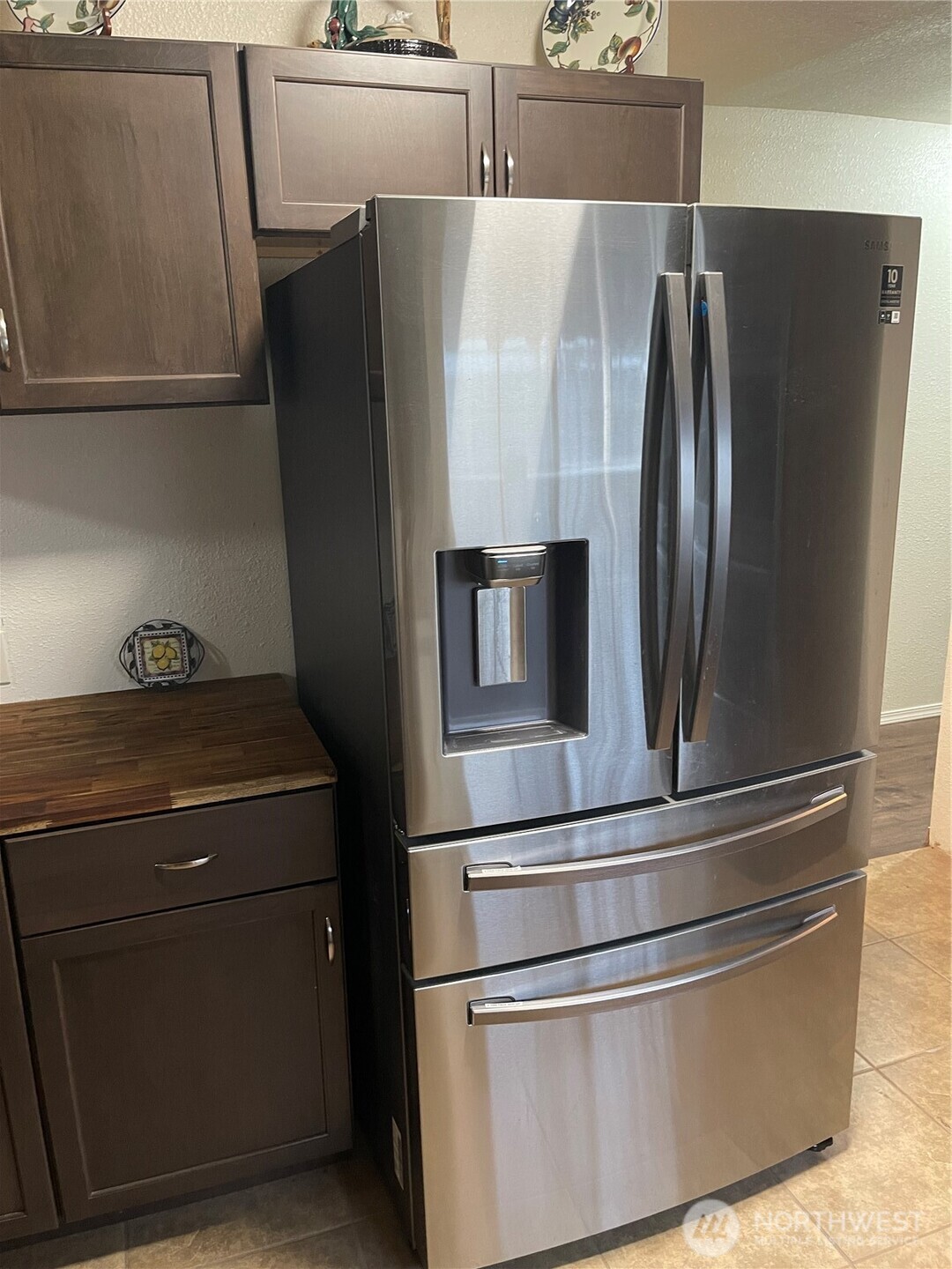 212 West 4th Street Tonasket, WA 98855 - Photo 9 of 24 a metallic refrigerator freezer sitting in a kitchen