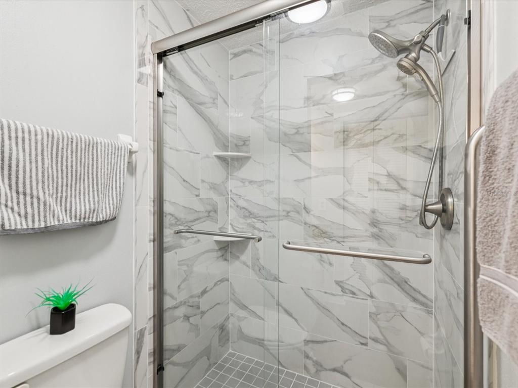 3683 Trophy Boulevard, Unit 7 New Port Richey, FL 34655 - Photo 13 of 42 a bathroom with a shower