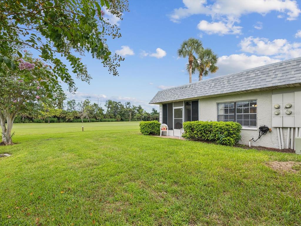 3683 Trophy Boulevard, Unit 7 New Port Richey, FL 34655 - Photo 20 of 42 a view of a house with a yard