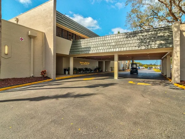 a view of a building with car parked