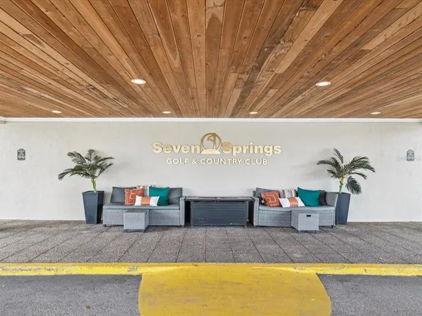 a swimming pool with outdoor seating