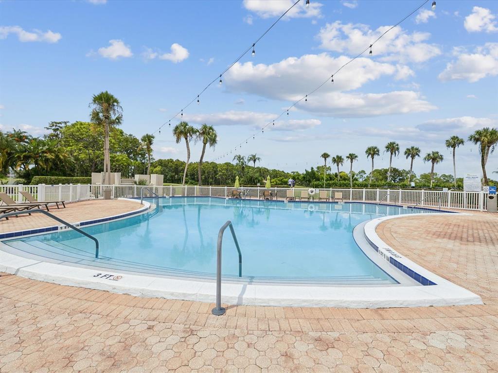 3683 Trophy Boulevard, Unit 7 New Port Richey, FL 34655 - Photo 34 of 42 a view of a lake with a house in the background