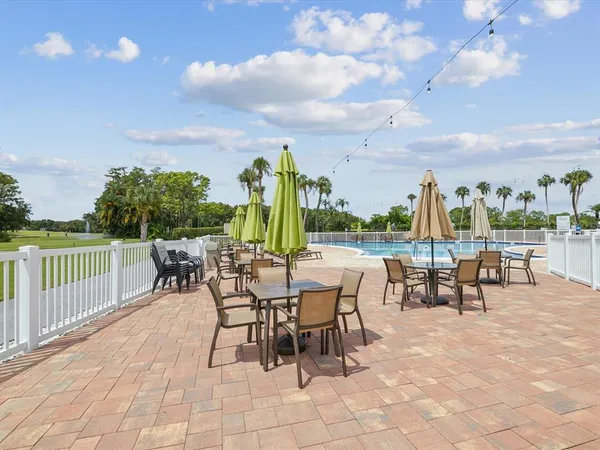 a view of a patio with a table and chairs