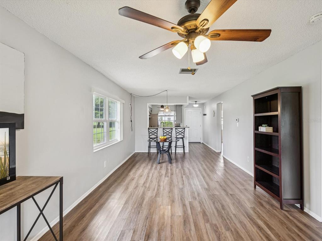 3683 Trophy Boulevard, Unit 7 New Port Richey, FL 34655 - Photo 4 of 42 a view of dining room and wooden floor
