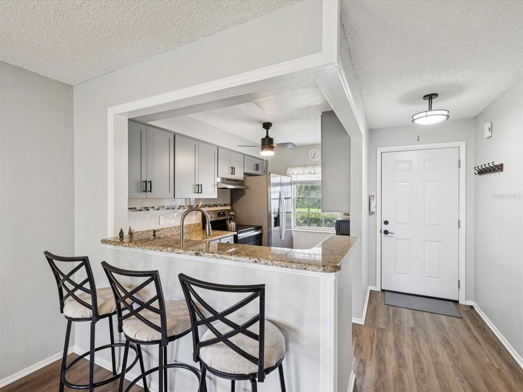 3683 Trophy Boulevard, Unit 7 New Port Richey, FL 34655 - Photo 6 of 42 a view of a dining room with furniture and wooden floor