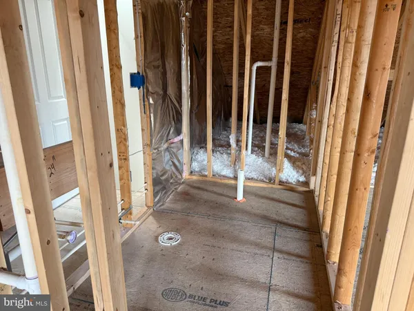 a view of an empty room with wooden walls