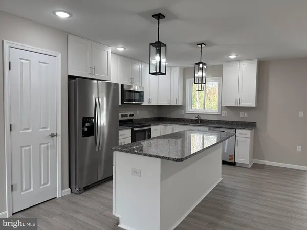 a view of a kitchen with a sink and cabinet