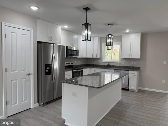 a view of a kitchen with a sink and cabinet