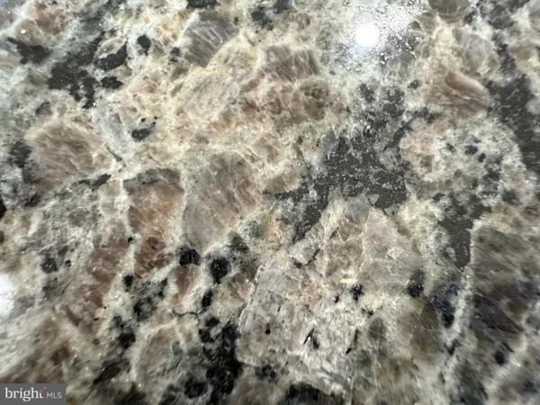 a kitchen with granite countertop a sink a stove and microwave