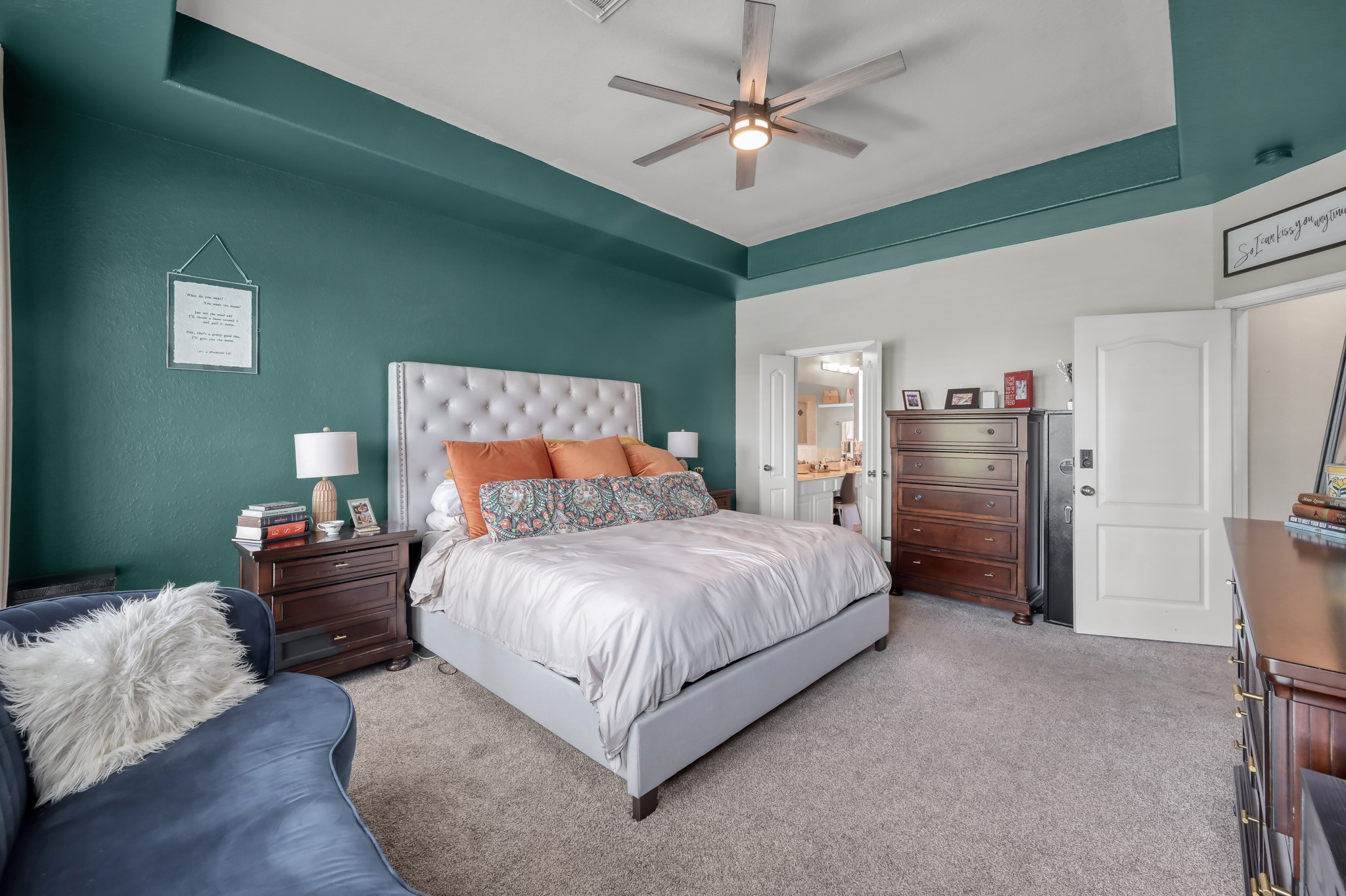 28522 Misty Cliff Lane Spring, TX 77386 - Photo 5 of 12 Beautiful primary bedroom featuring tray ceilings, plush carpeting, and a spacious layout with direct access to the ensuite bath. Neutral finishes provide a calm and inviting atmosphere.