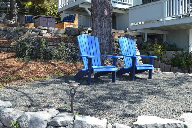 a view of backyard with outdoor seating and plants