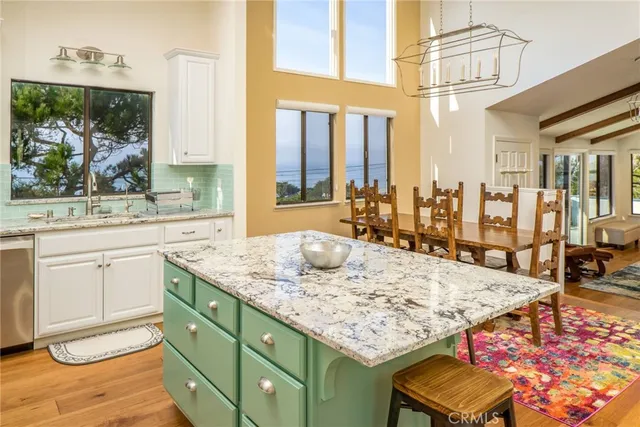 a living room with kitchen island granite countertop furniture and a fireplace