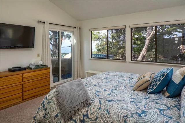a bedroom with bed and flat screen tv