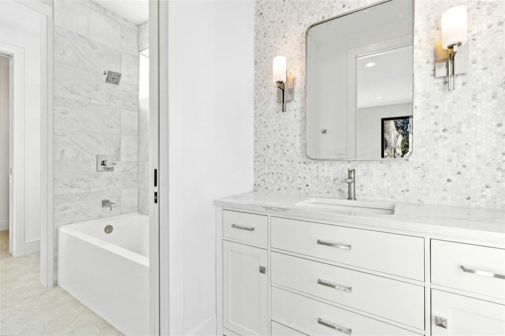 4311 Merrell Road Dallas, TX 75229 - Photo 26 of 30 a bathroom with a bathtub sink double and mirror