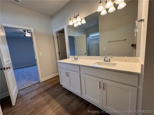 a spacious bathroom with a double vanity sink and a mirror