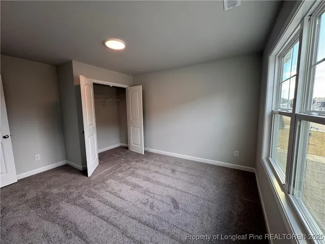 a view of a room with wooden floor and windows