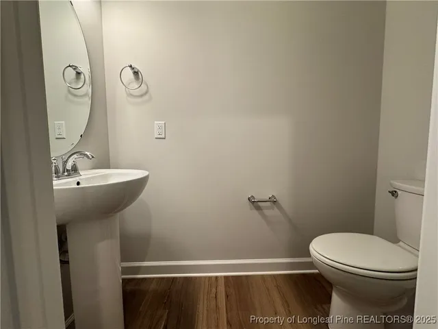 a view of a kitchen with wooden floor and a sink