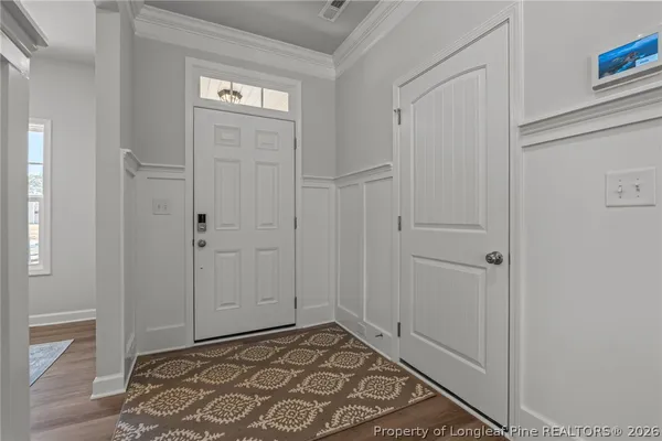 a kitchen with stainless steel appliances granite countertop a stove top oven a sink dishwasher and a refrigerator with wooden floor