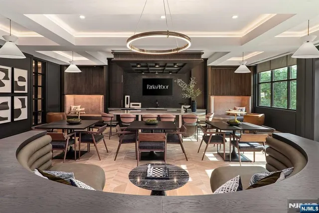 a living room with furniture gym equipment and view of kitchen