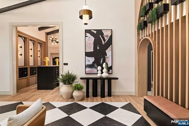 a living room with furniture and a chandelier