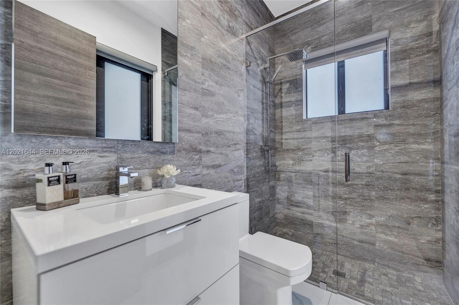 7800 Southwest 9th Terrace Miami, FL 33144 - Photo 18 of 64 a bathroom with a toilet sink and mirror