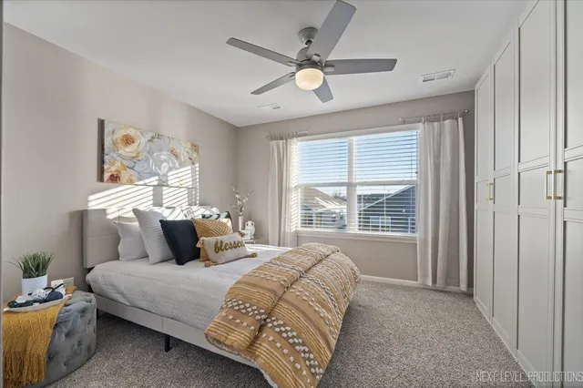 a bedroom with a bed and a chandelier