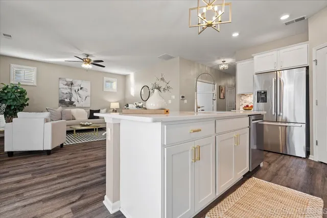 a kitchen with a stove and a chandelier