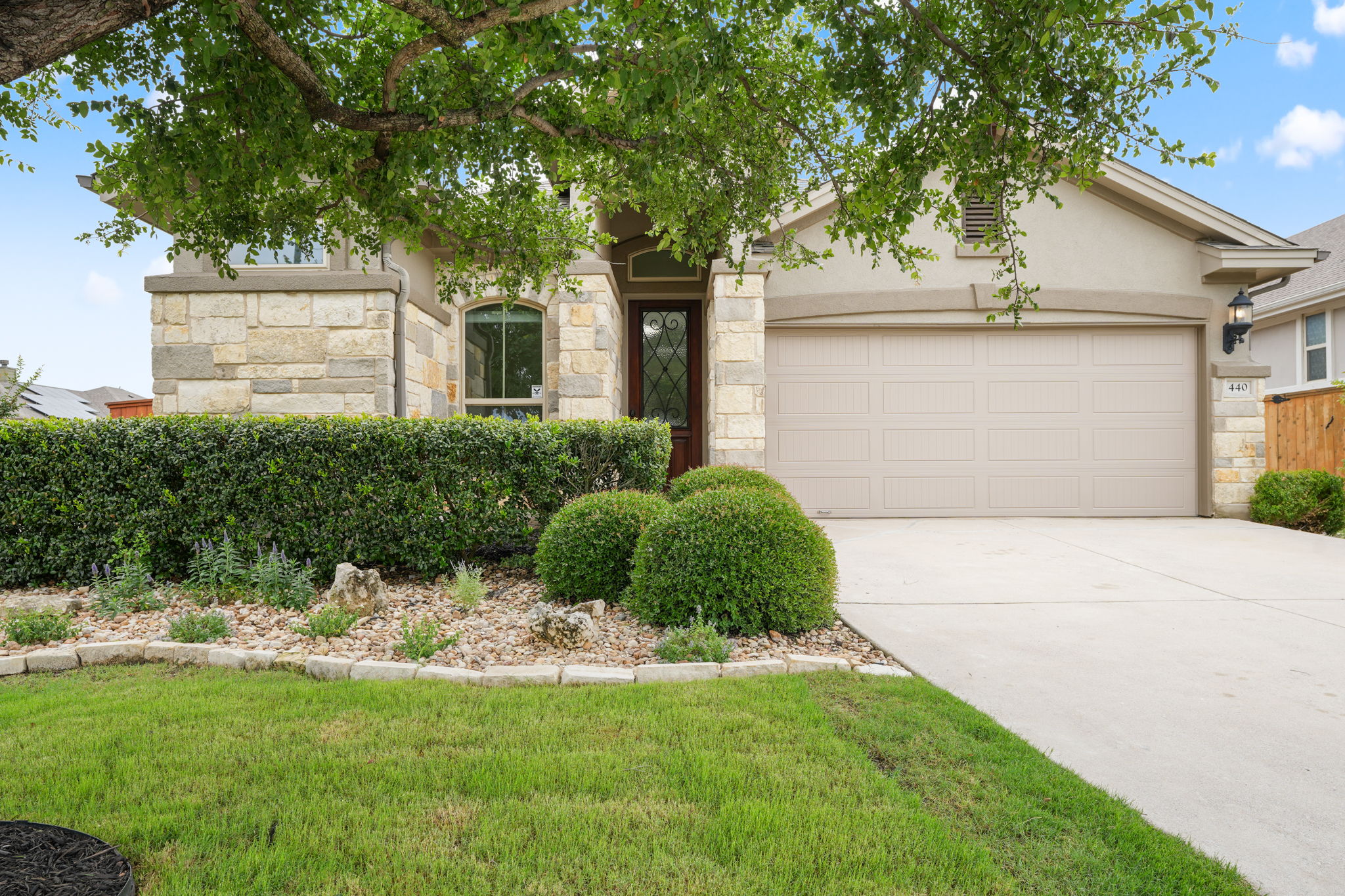 Well-maintained landscaping and a spacious driveway enhance the home's inviting curb appeal.