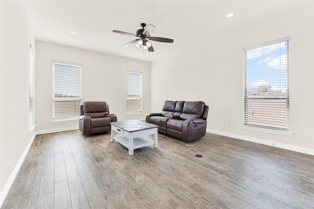 834 Audra Circle Rhome, TX 76078 - Photo 16 of 33 a living room with furniture and a wooden floor