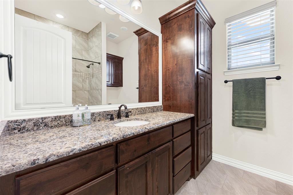 834 Audra Circle Rhome, TX 76078 - Photo 17 of 33 a bathroom with a granite countertop sink and a mirror